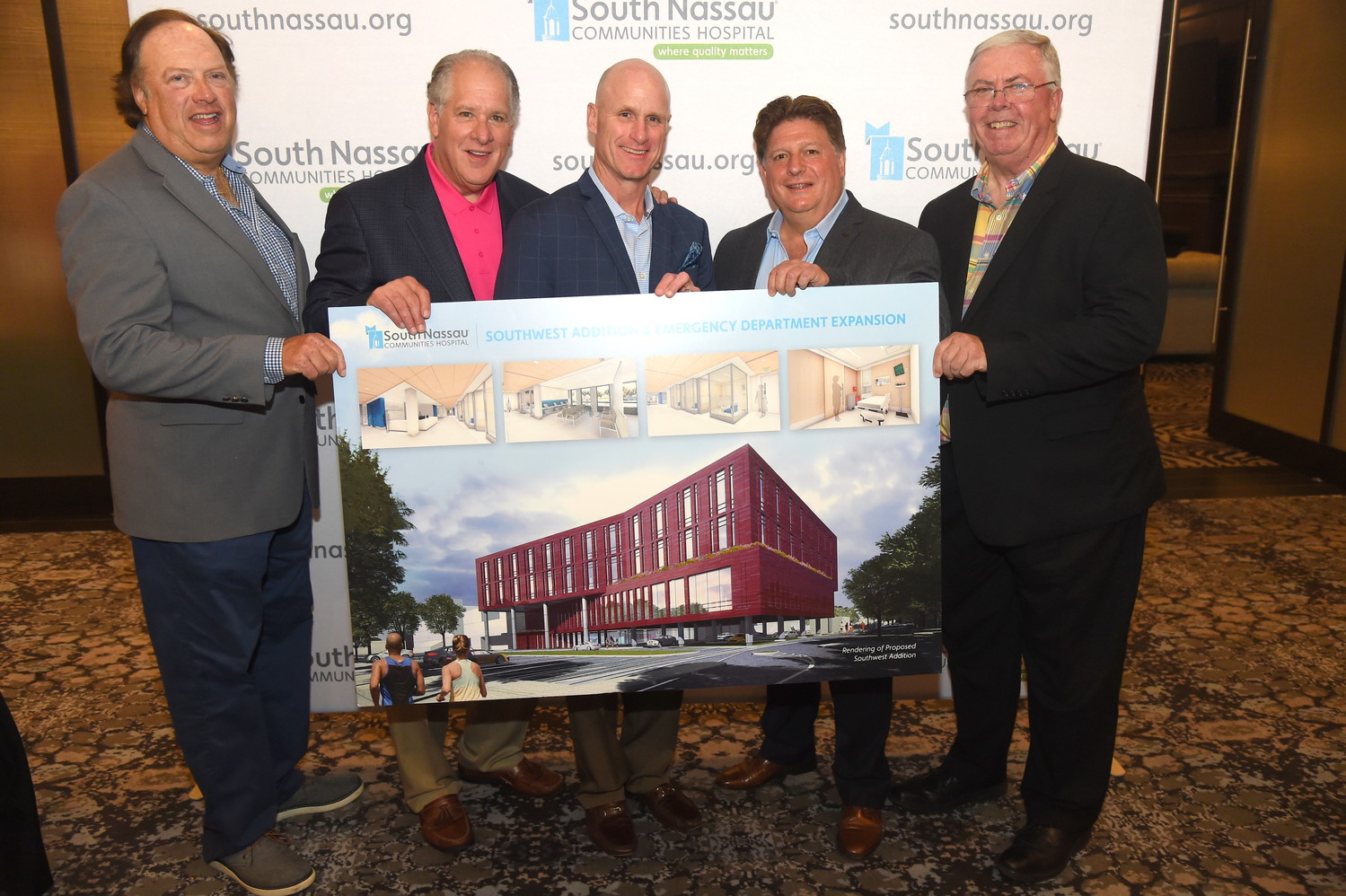 Golf outing co-chairs Jeff Greenfield, left, Tony Cancellieri, honorees Matt Whalen and Joel Schneider and South Nassau president and CEO Richard Murphy with a rendering of the hospital’s upcoming southwest addition.