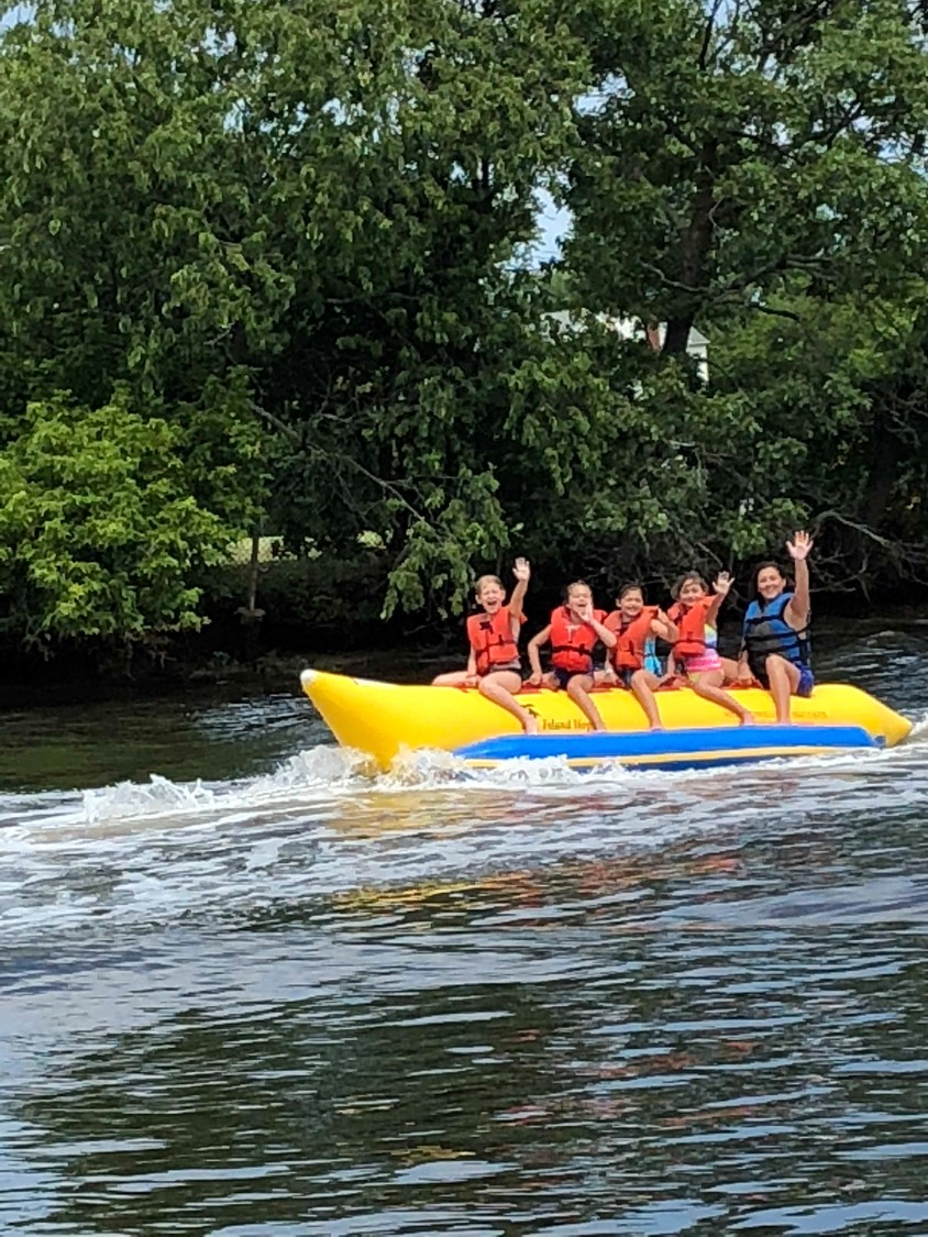 G7 Snappers camp group assistant counselor Brooke Geller, far right, rode with her campers on the banana boat at Rolling River Day Camp.