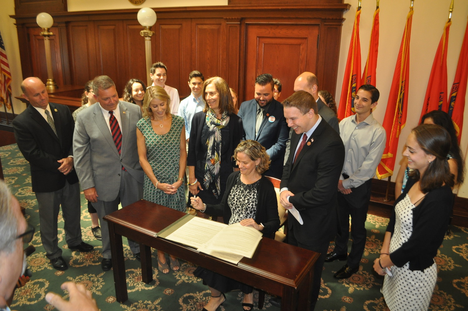 County Executive Laura Curran signed an anti-bullying bill authored by Legislator Josh Lafazan, to her left, surrounded by students and stakeholder organizations.