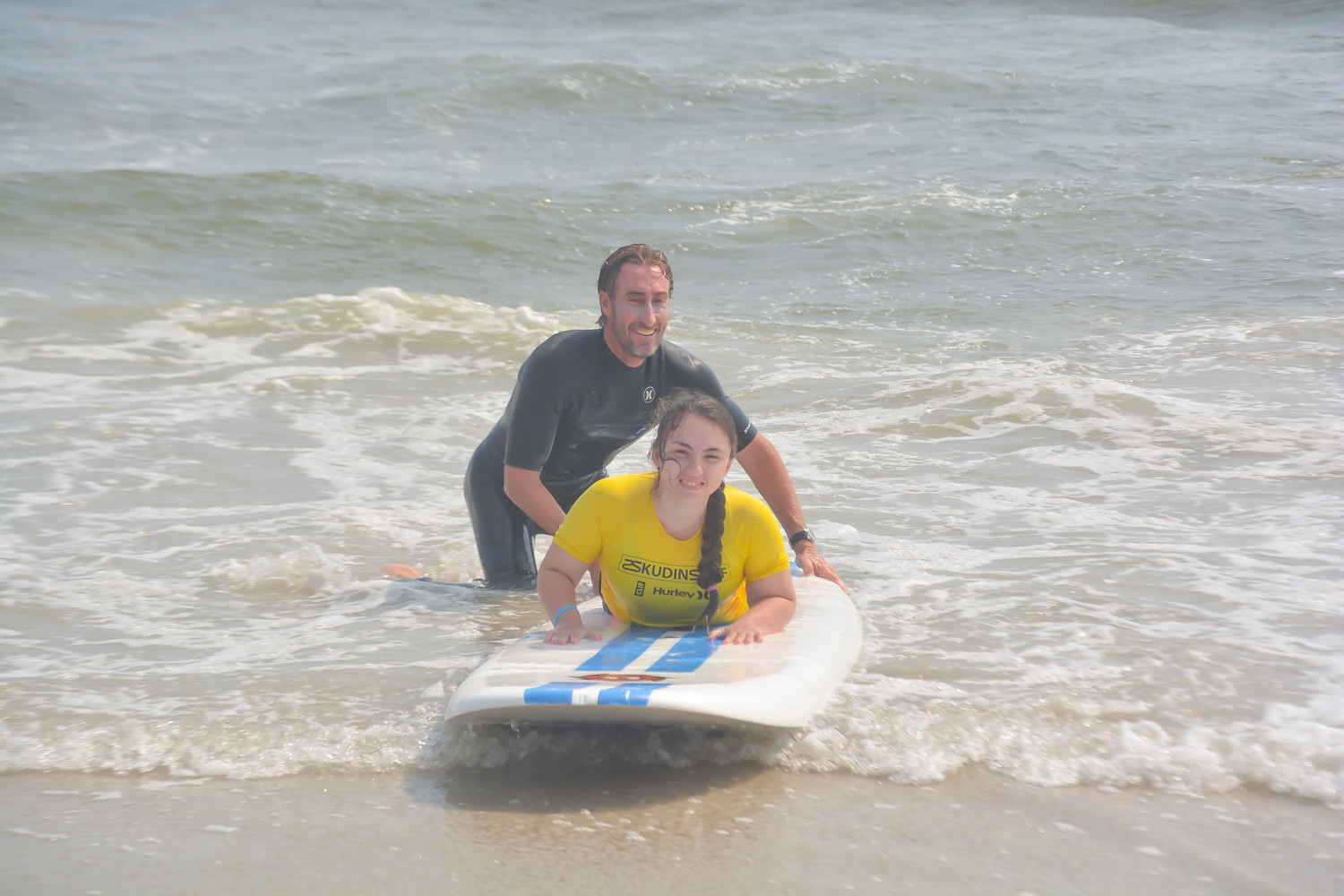 Sidorela Lleshi said she had a wonderful time surfing with the help of Skudin Surf instructor Adam Dufner during a trip to Long Beach sponsored by the Adaptive Sports Academy at the Hospital for Special Surgery on Aug. 15.