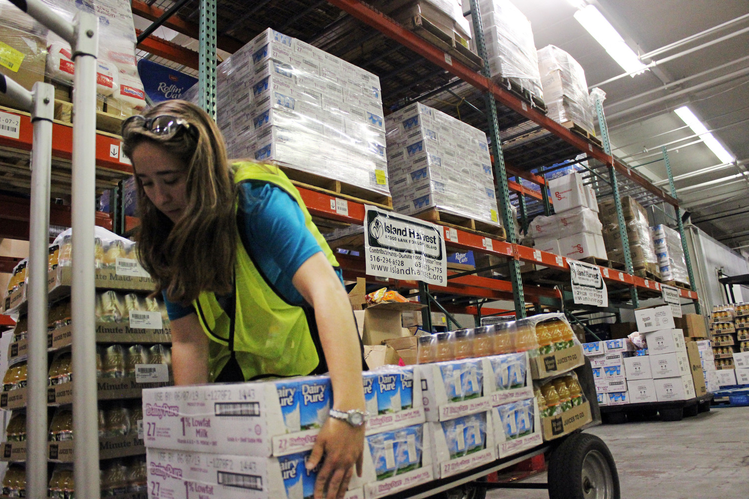 Island Harvest Food Bank and Jovia Financial Credit Union — formally NEFCU — will be providing meals to hundreds of affected by the Covid-19 pandemic. Above, Noelle Roth, was interning at Island Harvest and gathering food to distribute to students.