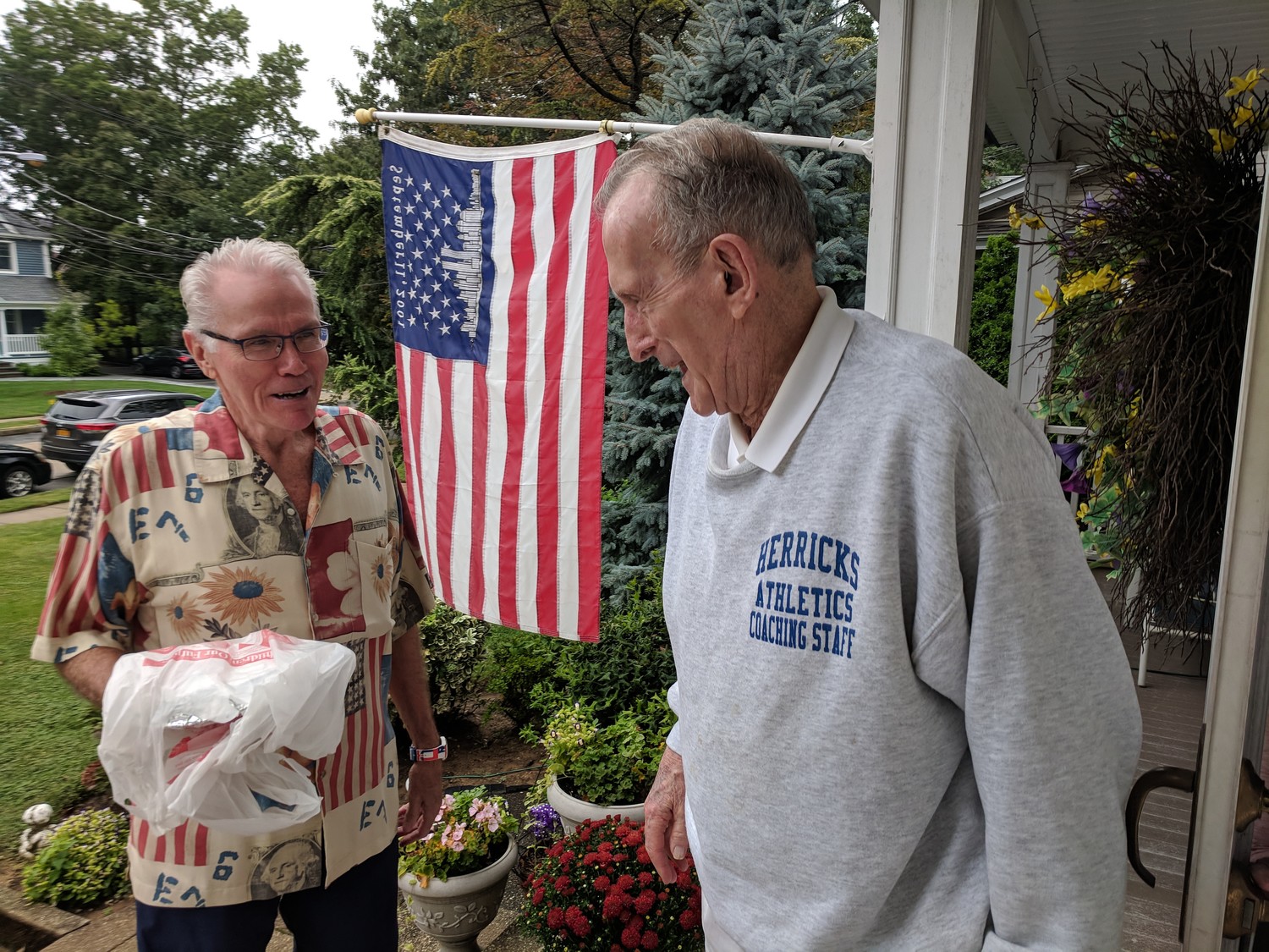 Joe O’Connor, left, who’s also known as the “pie man,” delivered an apple pie to Bernie O’Brien, who lost his son and son-in-law in the terrorist attacks on Sept. 11, 2001. O’Connor has been delivering pies to village residents who lost loved ones that day for the past 17 years.