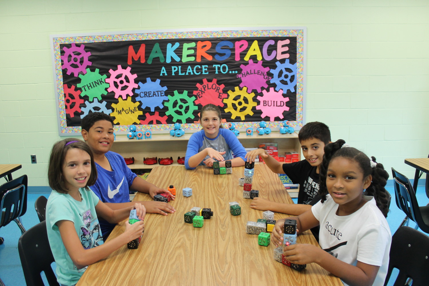 Students Mae Slade, left, Jayden Johnson, Anna Calabrese, Robert Griffo and Aliyah Lewis investigated Cubelet robots in Watson’s new makerspace.
