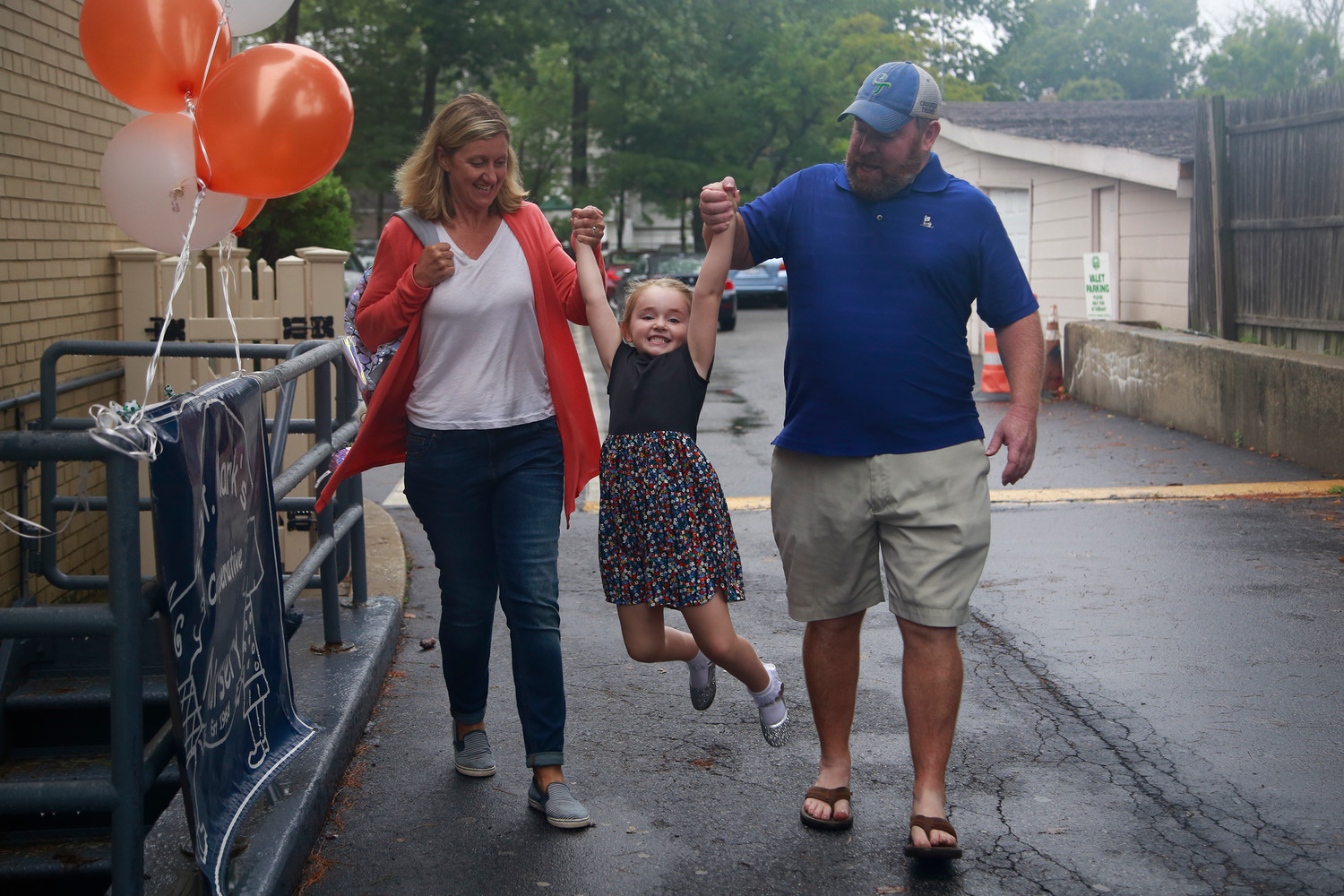 Liz and Chris O’Keefe swung their daughter, Abby, as they walked her to her first day of nursery school last month.