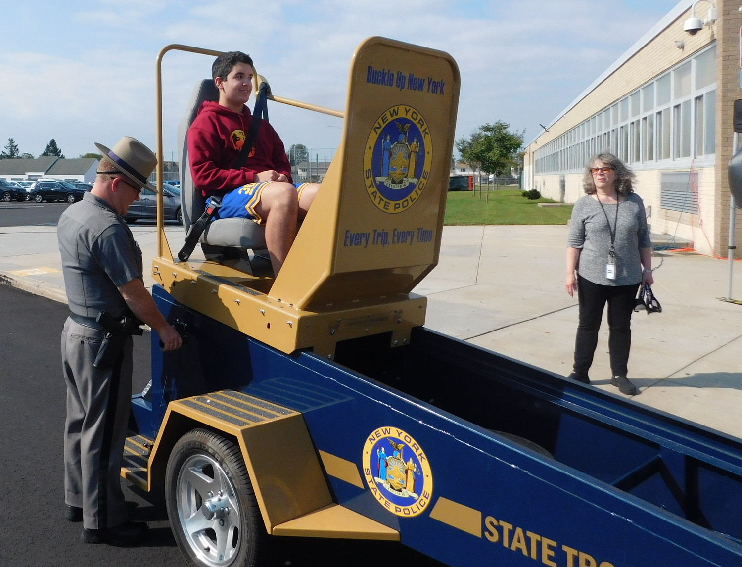The “seat belt convincer” was brought to John F. Kennedy High School. Daniel Delgado buckled in and received a five- to seven-mile-per-hour jolt, experiencing what a minor car accident feels like.