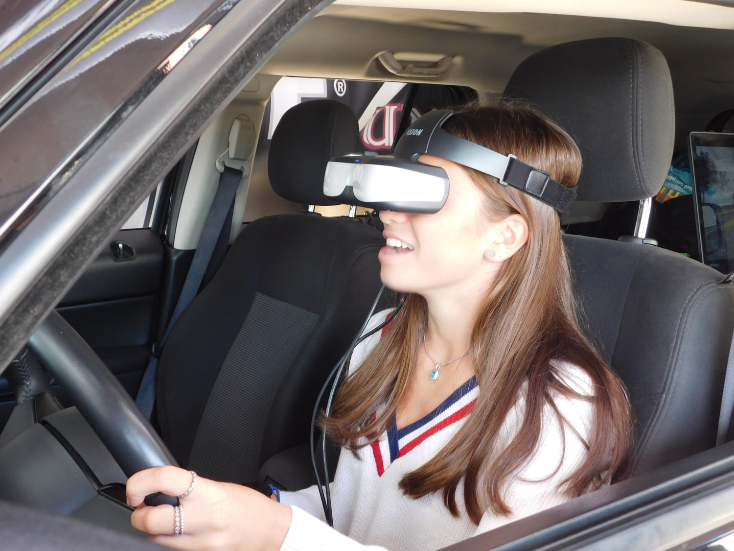 Isabella Pace donned the virtual reality headset and felt first-hand the difficulty of driving while texting.