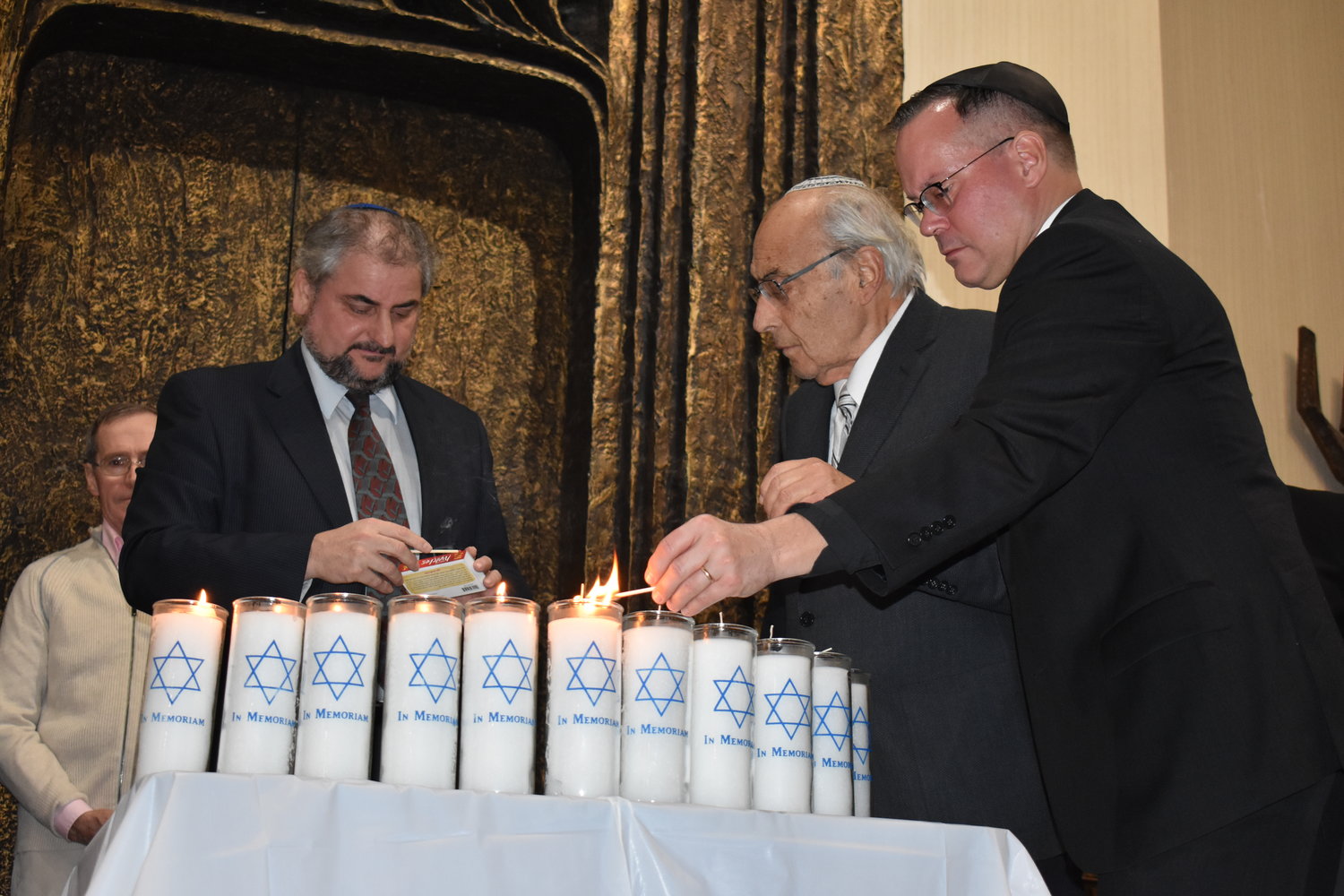 Candles were lit for each of the victims of the shooting at the Tree of Life Synagogue in Pittsburgh, from left, Rabbi Claudio Kupchick of Temple Beth El, center, Rabbi Arnold Marans of the Sephardic Temple and Father Christopher Ballard of Trinity-St. John’s Episcopal Church.