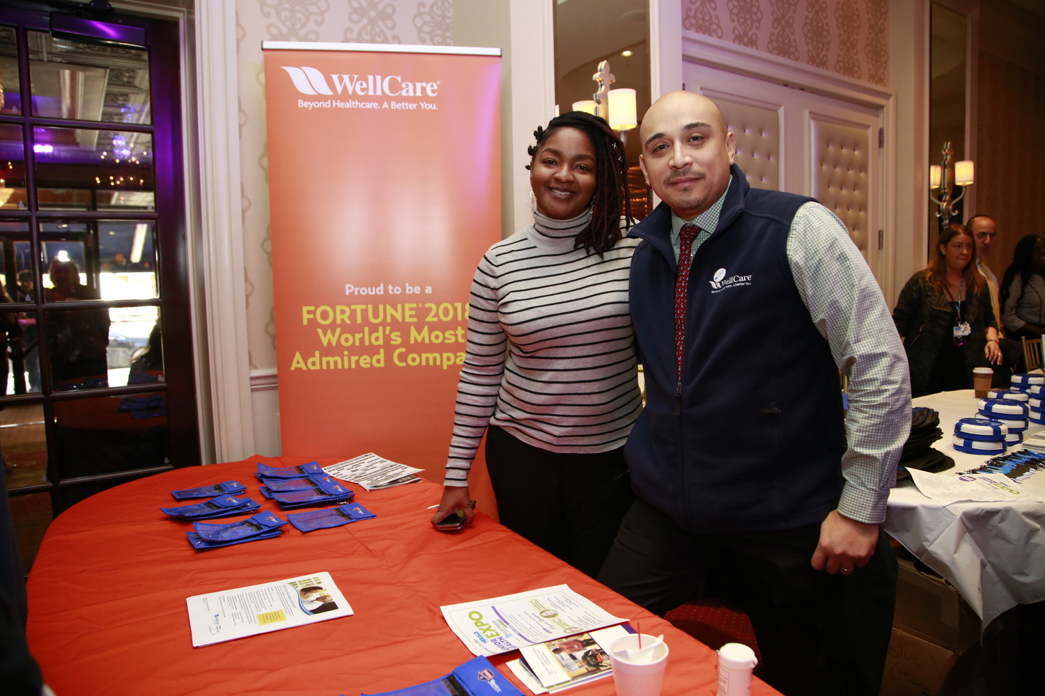 Speaker Walter Aguilar, Director MLTC Assessment & Enrollment, WellCare Health Plans, Inc. with Maza Myrie, marketing and events specialist, during the event.