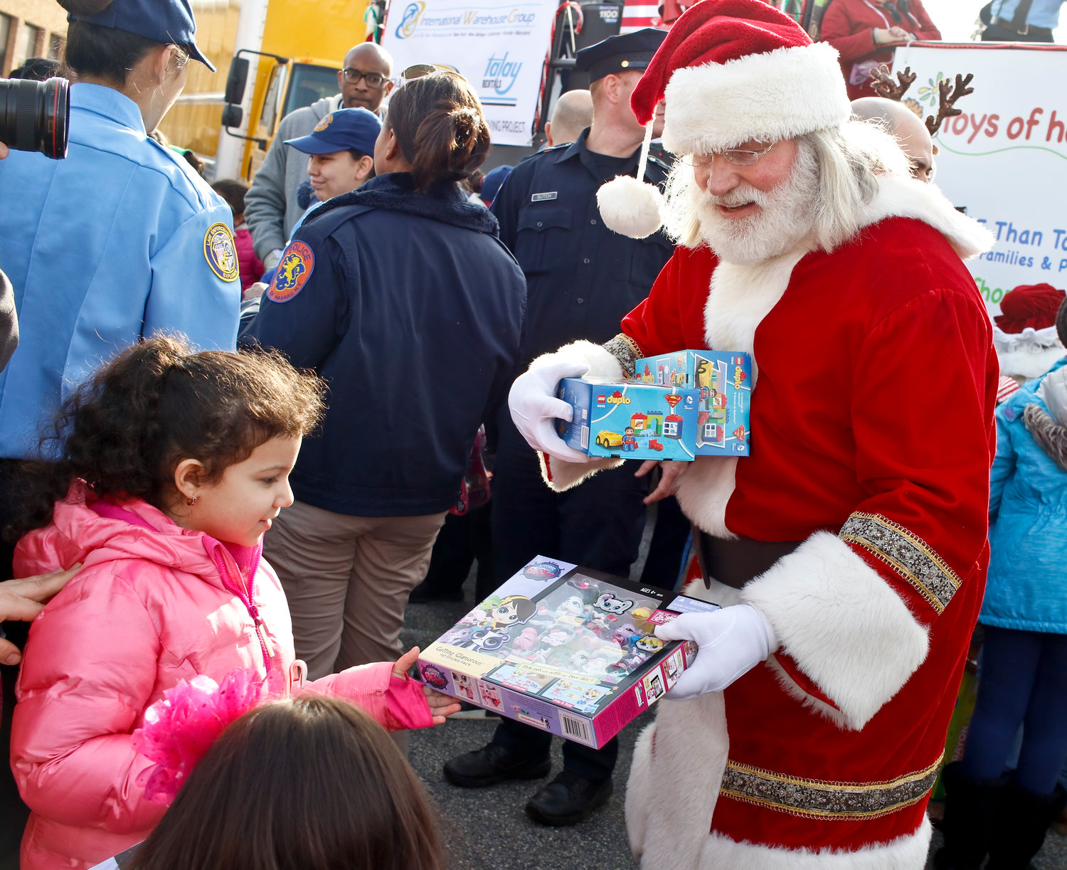 Santa Claus gave a Pet Shop set to Helen Salguero at the toys of hope event. Each child at the event received a toy.