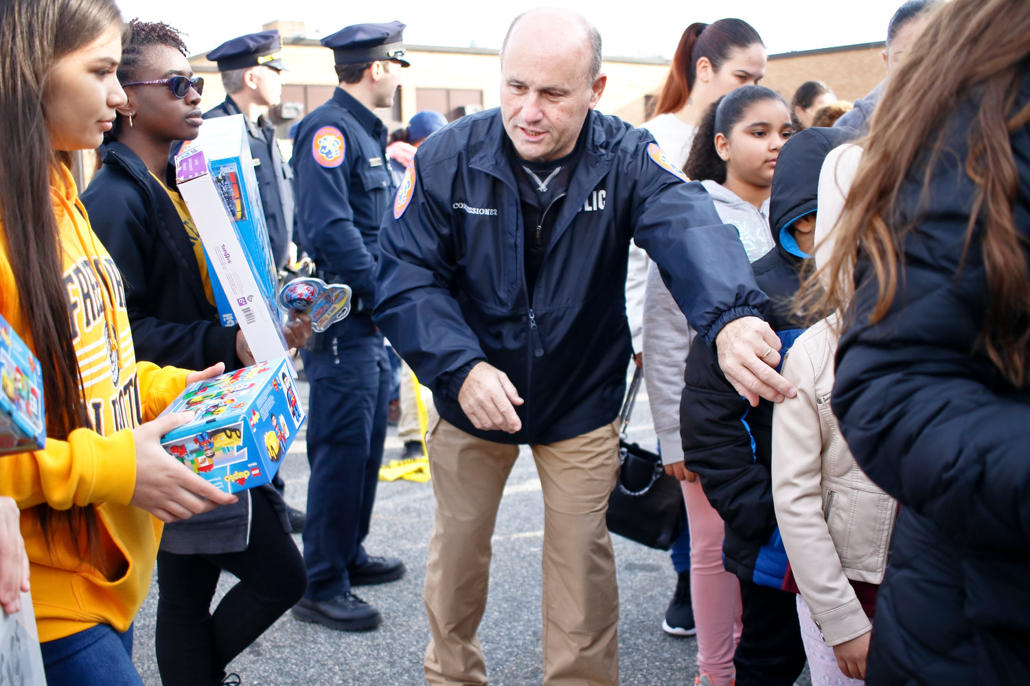 Police Commissioner Patrick Ryder helped hand out toys to the hundreds of children gathered at Freeport High School.