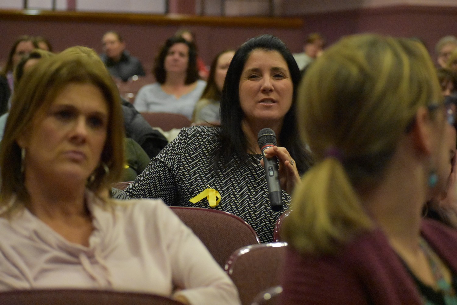 Karen Burgie, holding microphone, a Special Education Partners representative, was among dozens of parents at the Board of Education meeting on Dec. 5.