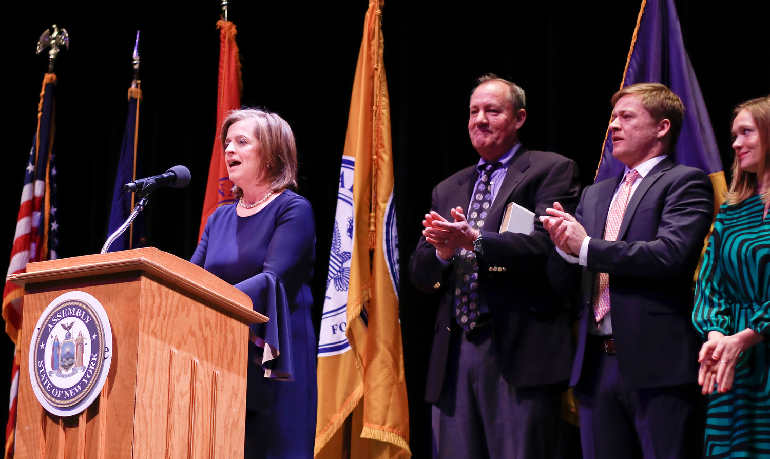 State Assemblywoman Judy Griffin, left, addressed the crowd after being sworn in at Molloy College’s Madison Theatre on Jan. 13.