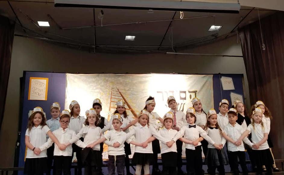 Linked together, Brandeis first-graders received prayer books and celebrated their Jewish spirit.