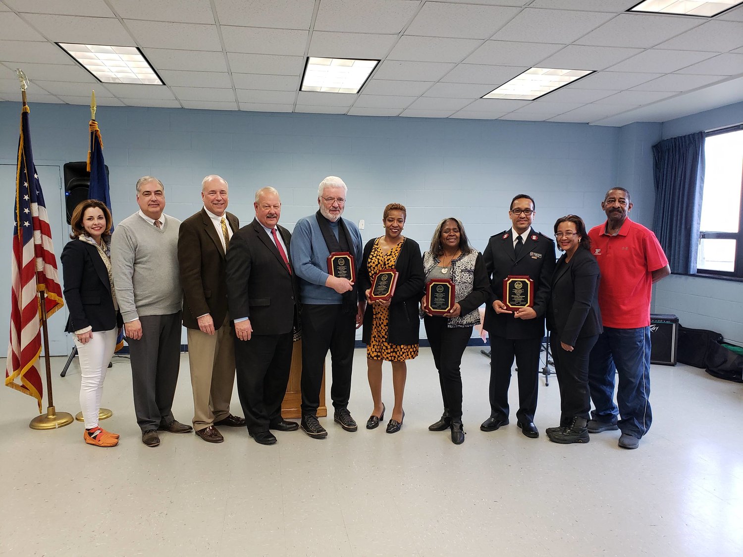 After the ceremony, Town of Hempstead Councilwoman Erin King Sweeney, far left, joined Freeport board of trustees members Jorge Martinez and William White, Mayor Robert Kennedy, the four honorees, Carmen Pineryo and Ron Ellerbe.