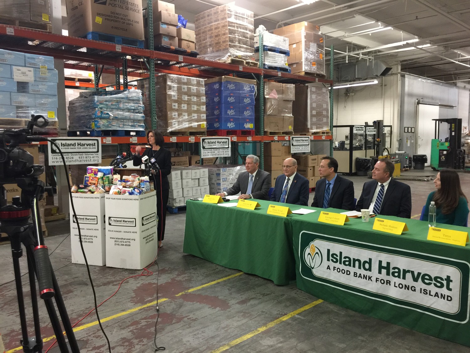 At a news conference on Jan. 17 at Island Harvest Food Bank, its president and chief executive officer, Randi Shubin Dresner, of East Meadow, joined local nonprofit, businesses and government leaders to announce that they would offer assistance to federal employees and contractors impacted by the government shutdown. Seated, from left, were Robert Allen, president and CEO of the Teachers Federal Credit Union; John Imhof, commissioner of the Nassau County Department of Social Services; Dennis Nowak, acting commissioner of the Suffolk County Department of Social Services; George Coburn, manager of customer experience at PSEG Long Island, and Stefanie Shuman, manager of external communications and community relations at Stop & Shop.