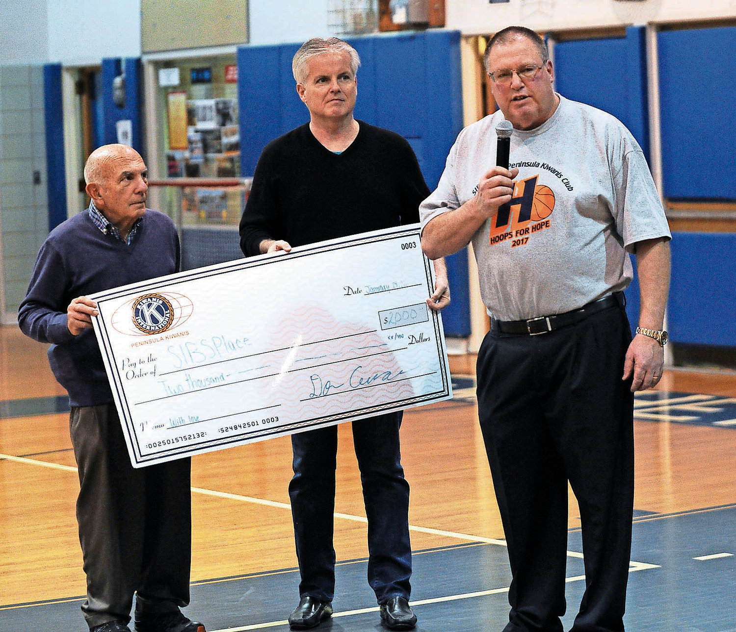 Through its Hoops for Hope game on Feb. 9, the Hewlett High School varsity basketball teams aims to raise $15,000 for its programs and SIBSPlace. At the 2017 game, SIBSPlace founder Michael Schamroth, left, Peninsula Kiwanis member Chris McGrath and Hewlett boys’ basketball coach Bill Dubin.