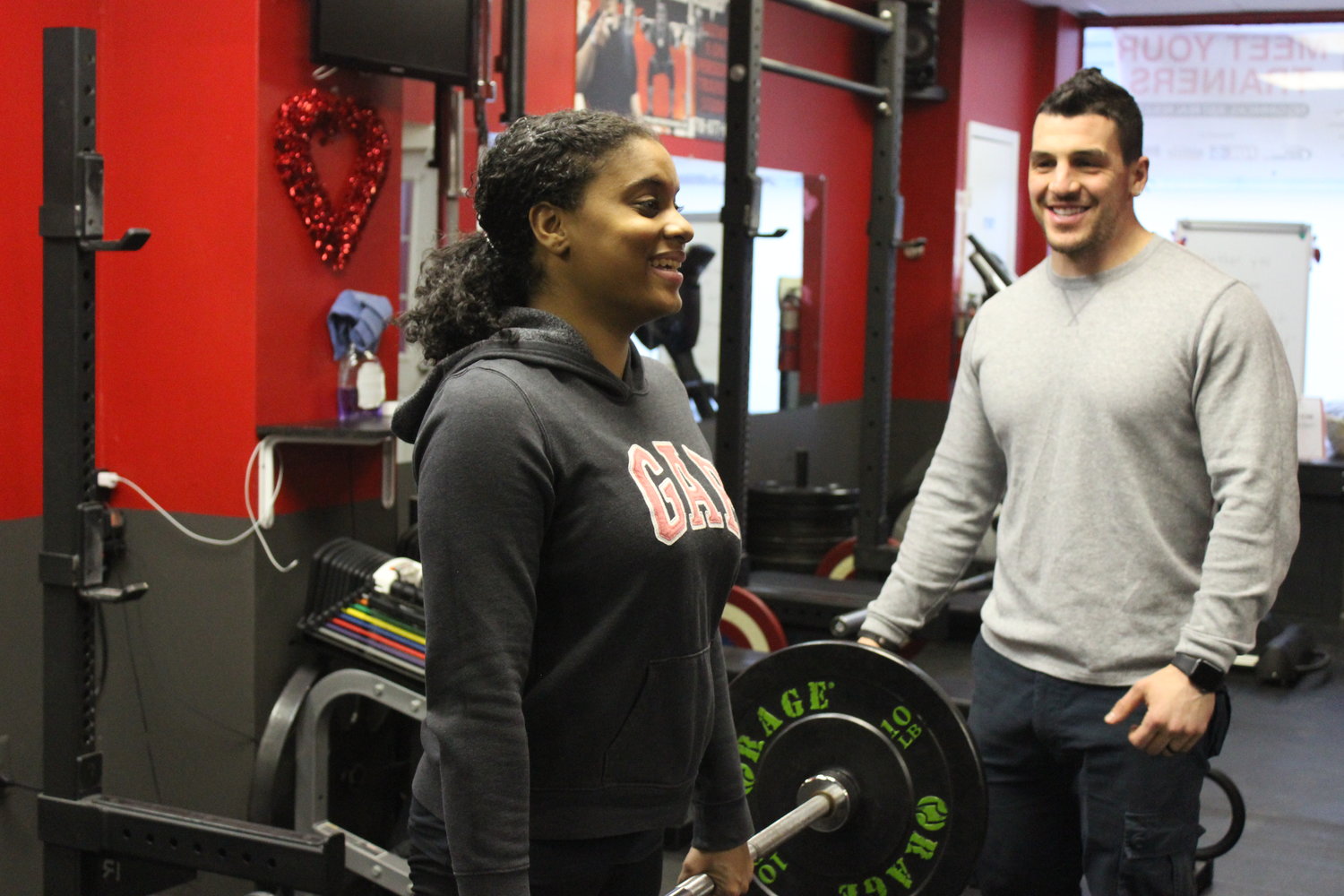 Yanelin Gonzalez, 23, of Copiague, left, began working out with Anthony Bevilacqua at AB Fitness Center, in East Meadow, after recovering from a series of health complications related to her kidneys, including cancer, which she survived as a baby.