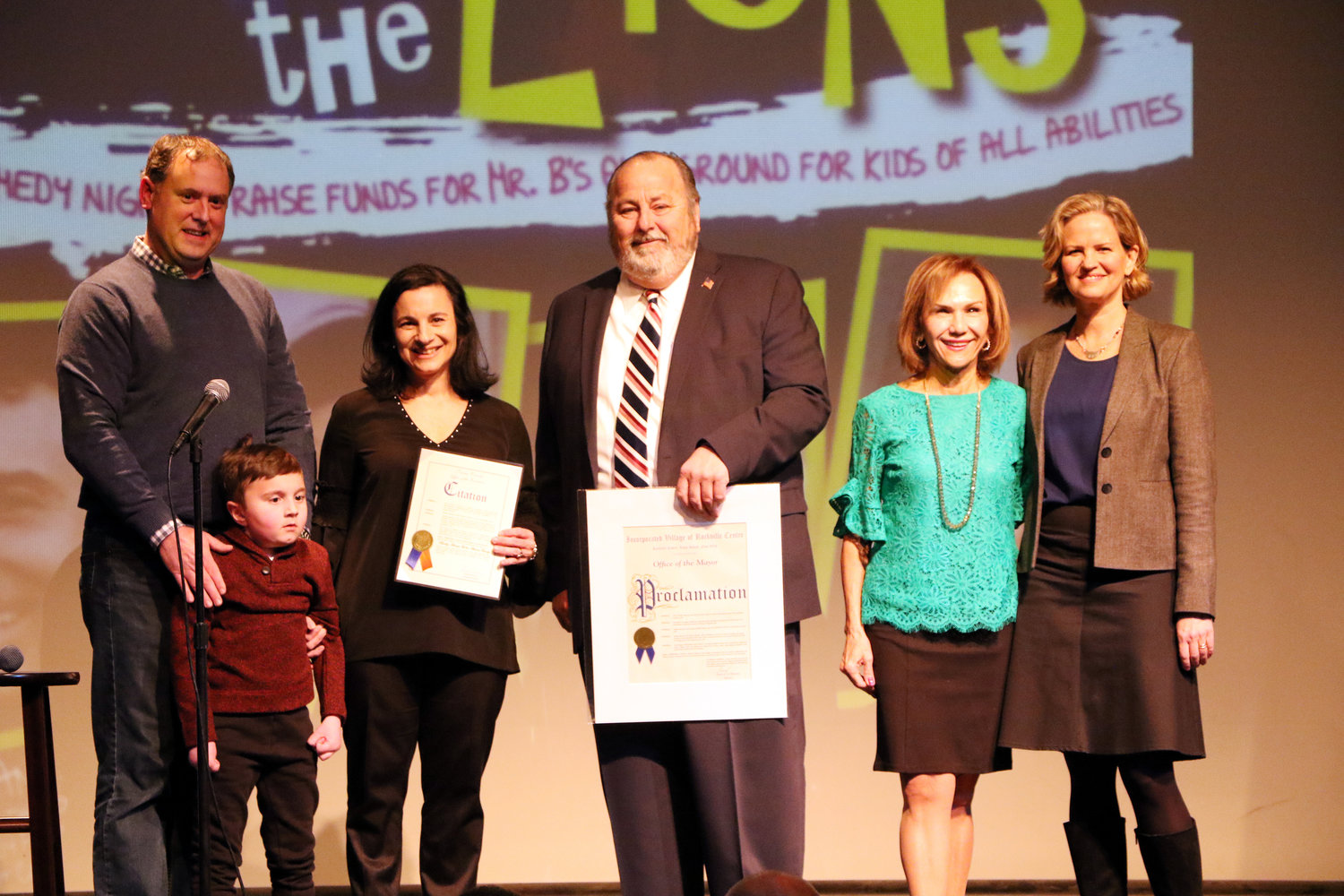 Buddy, with his father, Jonathan, left, and mother, Wendy, were honored by Mayor Francis X. Murray, Lions Club President Joan MacNaughton and Nassau County Executive Laura Curran.