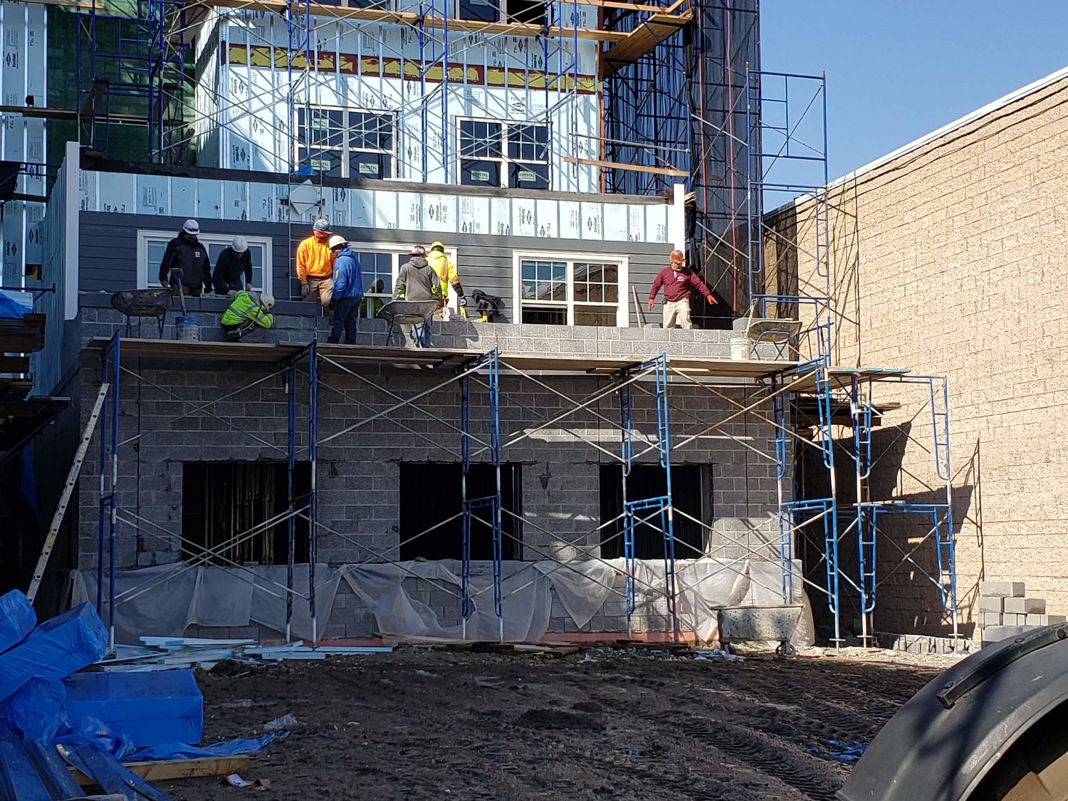 Construction workers were seen working on the new apartment building’s exterior.