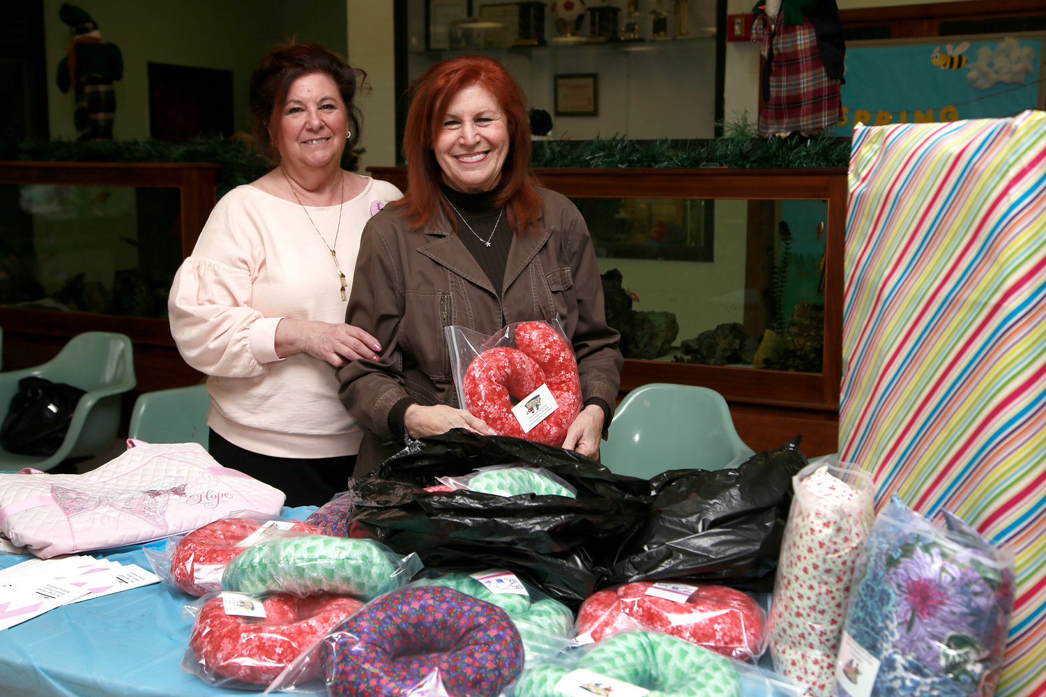 Geri Barish, of Hewlett House, was grateful for the neck pillows made by the Rockville Centre Homemakers, represented by Karen Alterson, the group’s co-president.