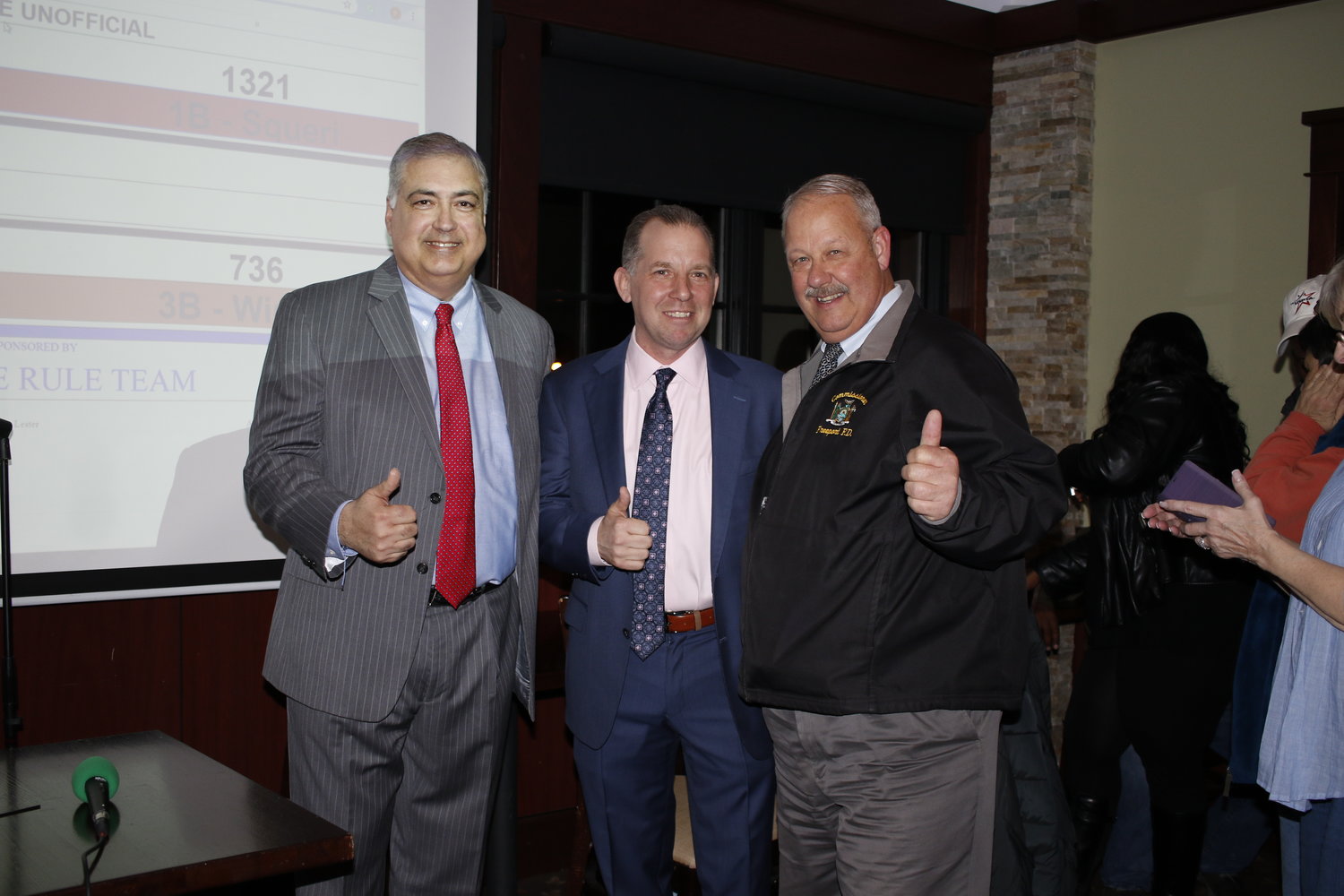 After the village election results were announced incumbent Deputy Mayor Jorge Martinez, left, newly elected Board of Trustee Chris Squeri, and   Mayor Robert Kennedy gave a thumbs up of approval.