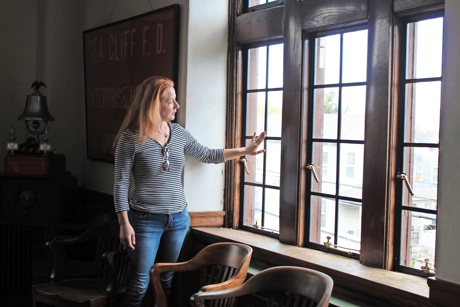Erinn McDonnell, the Village of Sea Cliff grant writer, looked out onto Roslyn Avenue through the newly restored windows of the Sea Cliff Firehouse.