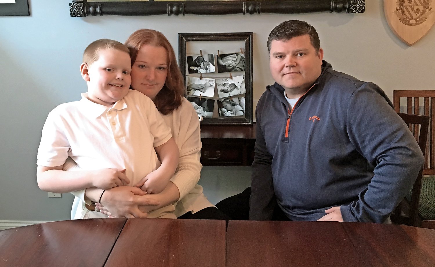 The Goodwins, William, 9, Maggie and Craig, keep photos of their stillborn daughter Emma-Méabh beside their dining room table.