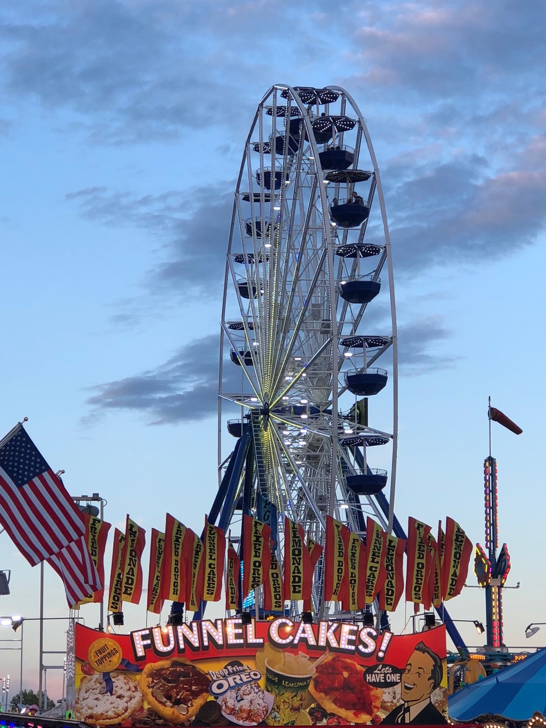 The giant Ferris wheel commands attention throughout the fairgrounds.