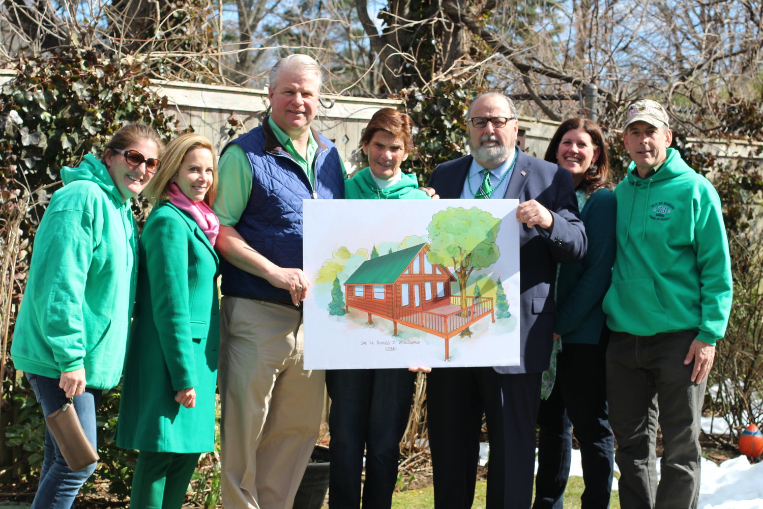 Kristine Winchester, far left, joined Town of Hempstead Supervisor Laura Gillen, Brian Rathjen, Marianna Winchester, Mayor Francis X. Murray, Deputy Mayor Kathleen Baxley and Michael Quilty at last year’s St. Patrick’s Parade. Winchester was presented with the rendering of a treehouse to be dedicated to her late son, Ronald, a Marine killed in Iraq in 2004.