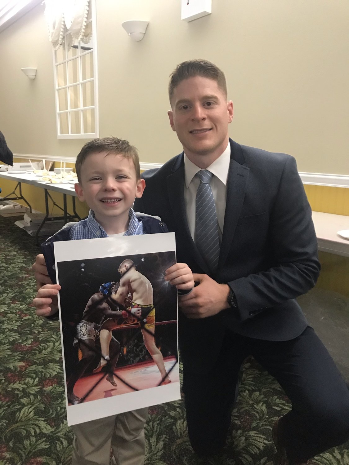Campbell, right, is a former Lynbrook Titans wrestler, and spent time with current Titans wrester Jack McAssey, 6, at the program’s annual awards ceremony in March.
