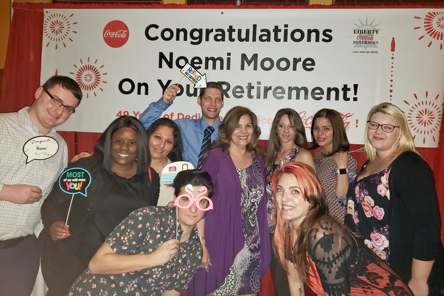 Noemi Moore, center, with her co-workers and team celebrating her retirement after nearly 50 years at Coca-Cola.
