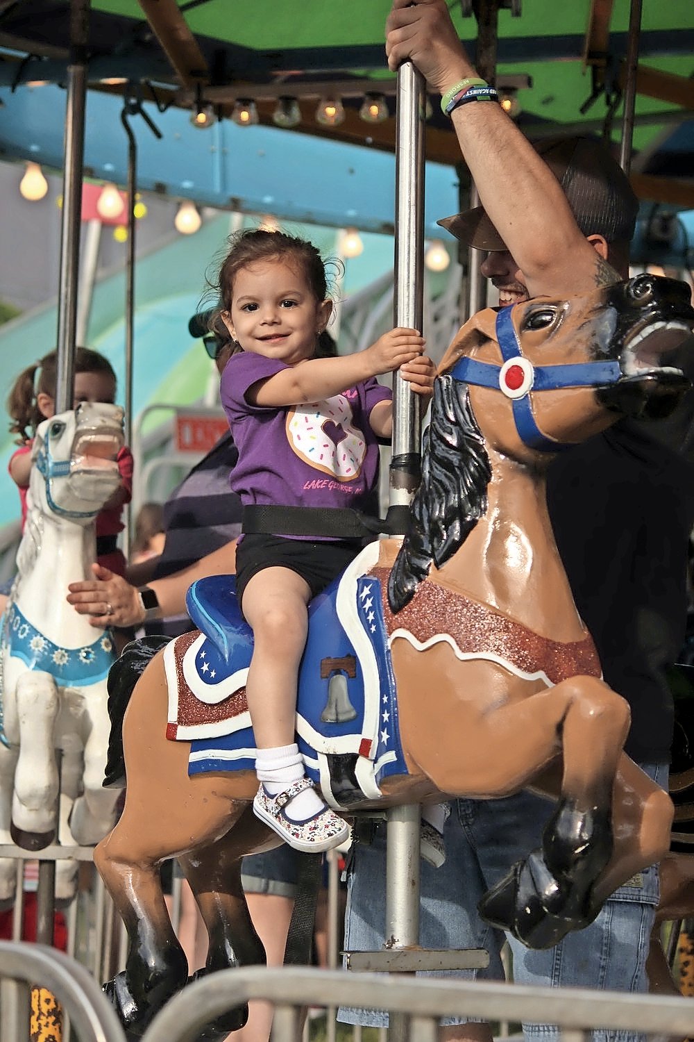 Hannah Demetriou, 2, took a regal spin on the carousel at last year’s feast.