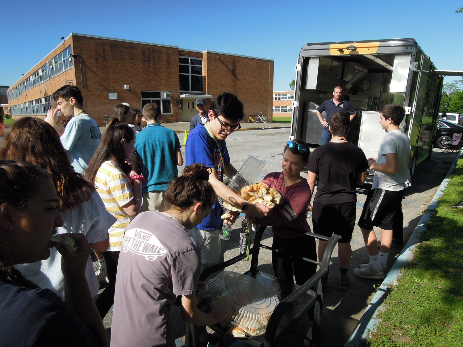 Seaford High School students helped themselves to bagels and beverages as Robbins looked on.