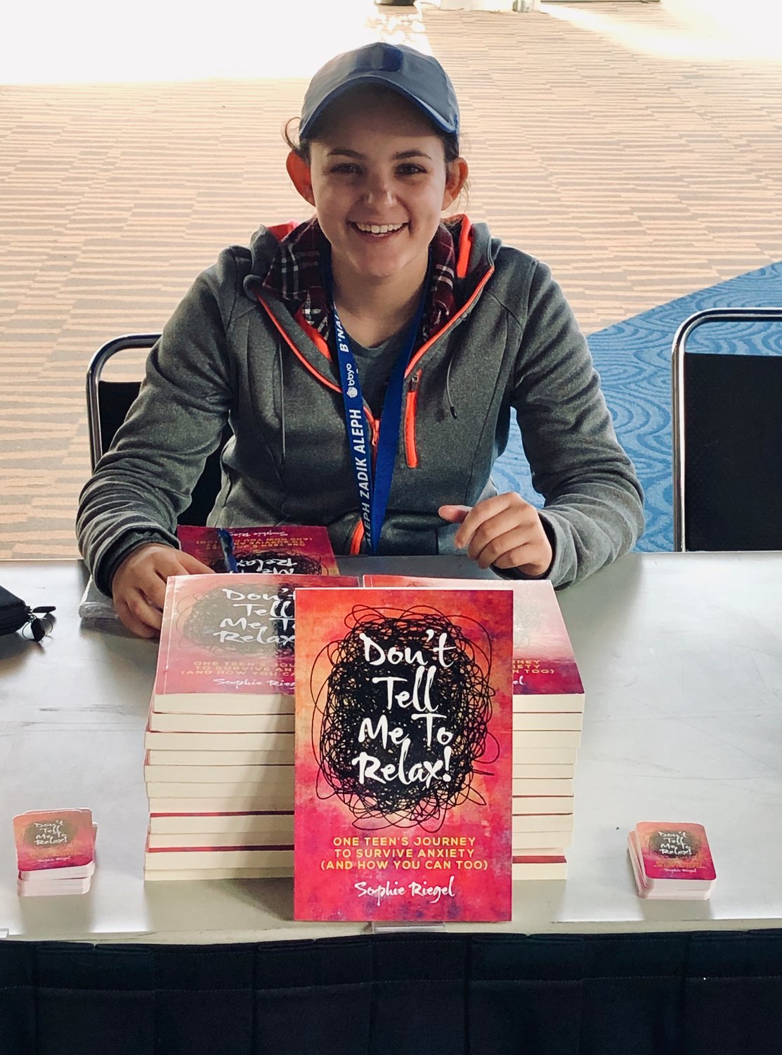 Hewlett High School senior Sophie Riegel signed copies of her book ‘Don’t Tell Me To Relax,’ at the BBYO event in February.