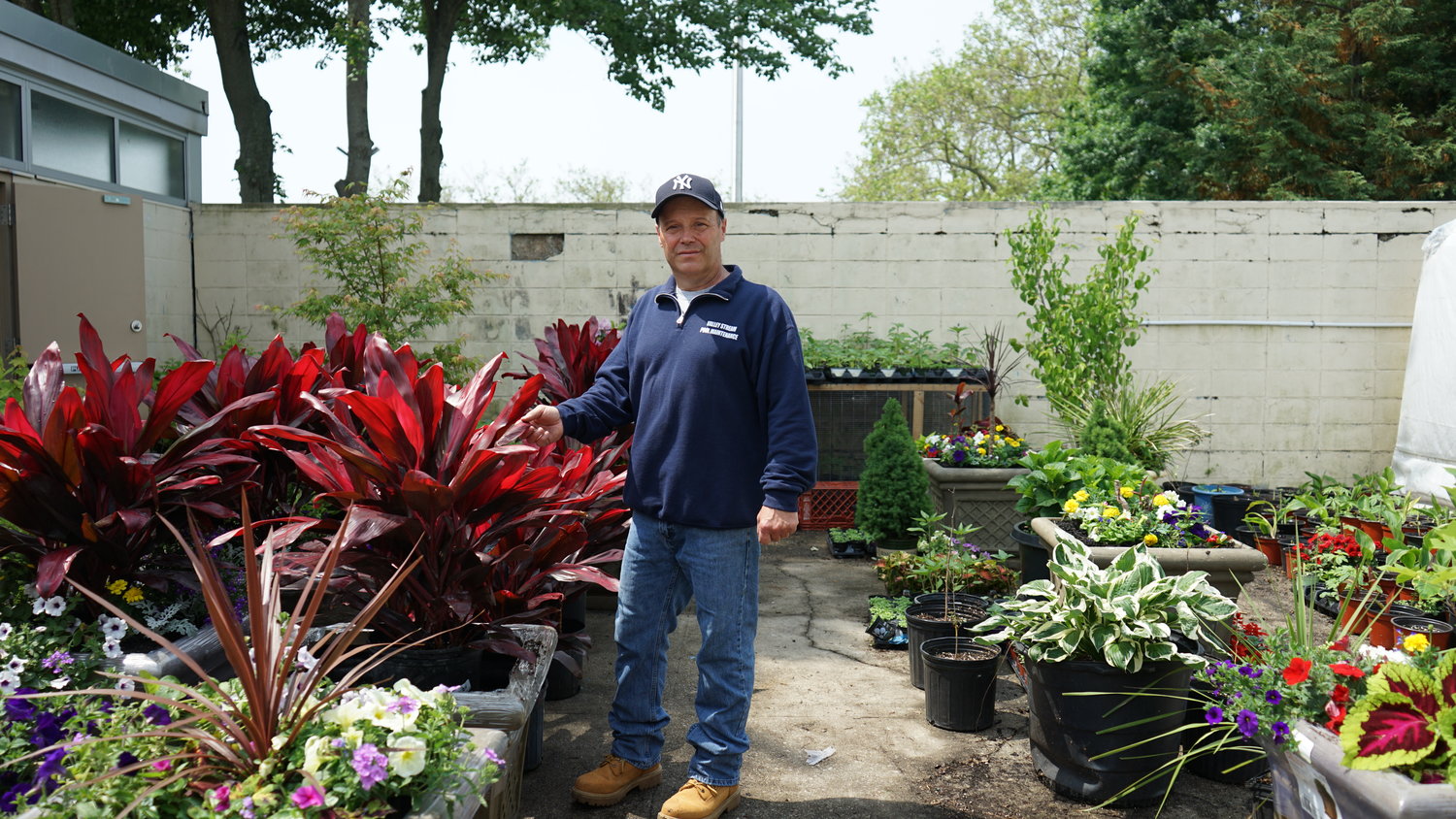 Village horticulturist Eugene Boening in his garden at the Hendrickson Park pool facility. His plant arrangements can be seen throughout Valley Stream.