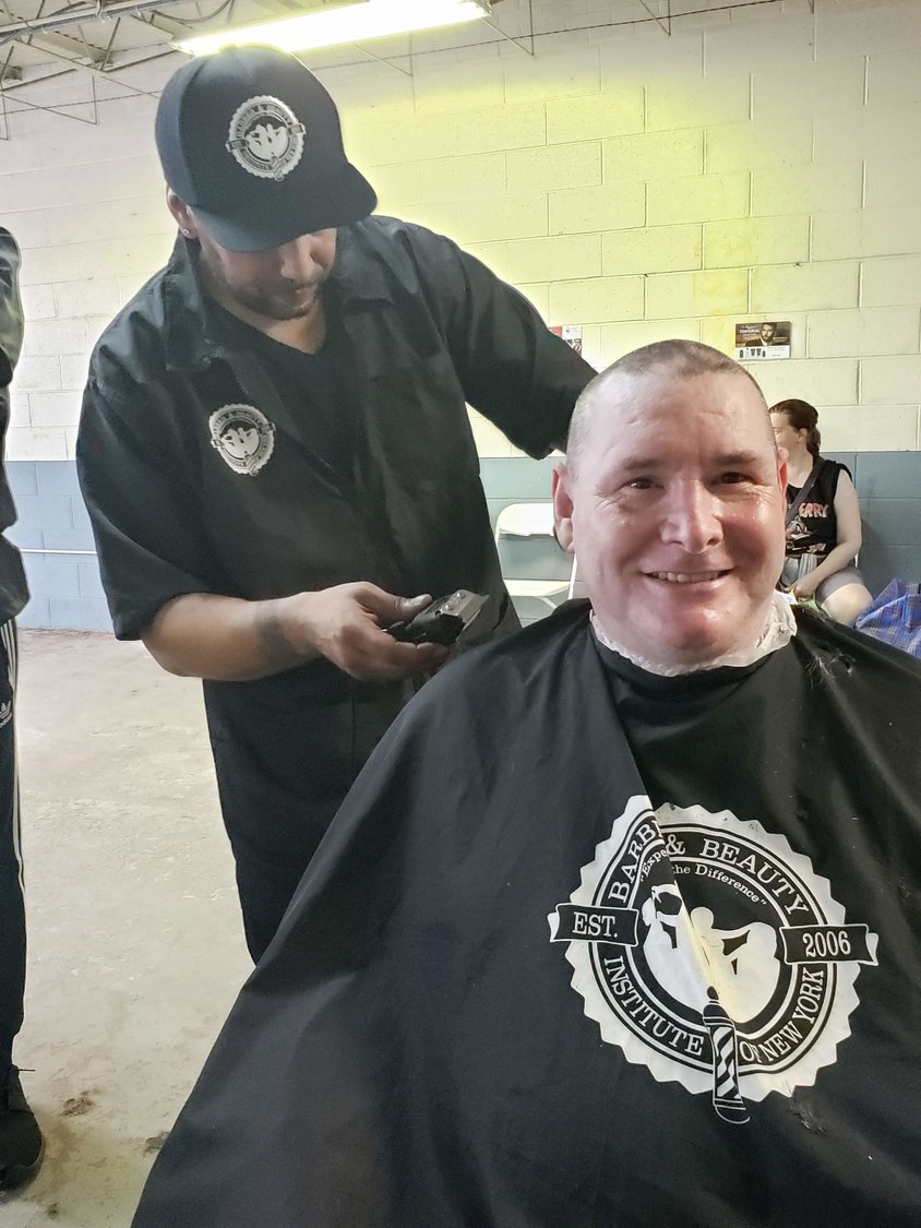 David Cornell, from Lynbrook, a Marine Corps veteran who fought in Operation Desert Storm in Kuwait, had his hair cut by Will Torres, of Queens Village, a student at the Barber and Beauty Institute of New York.