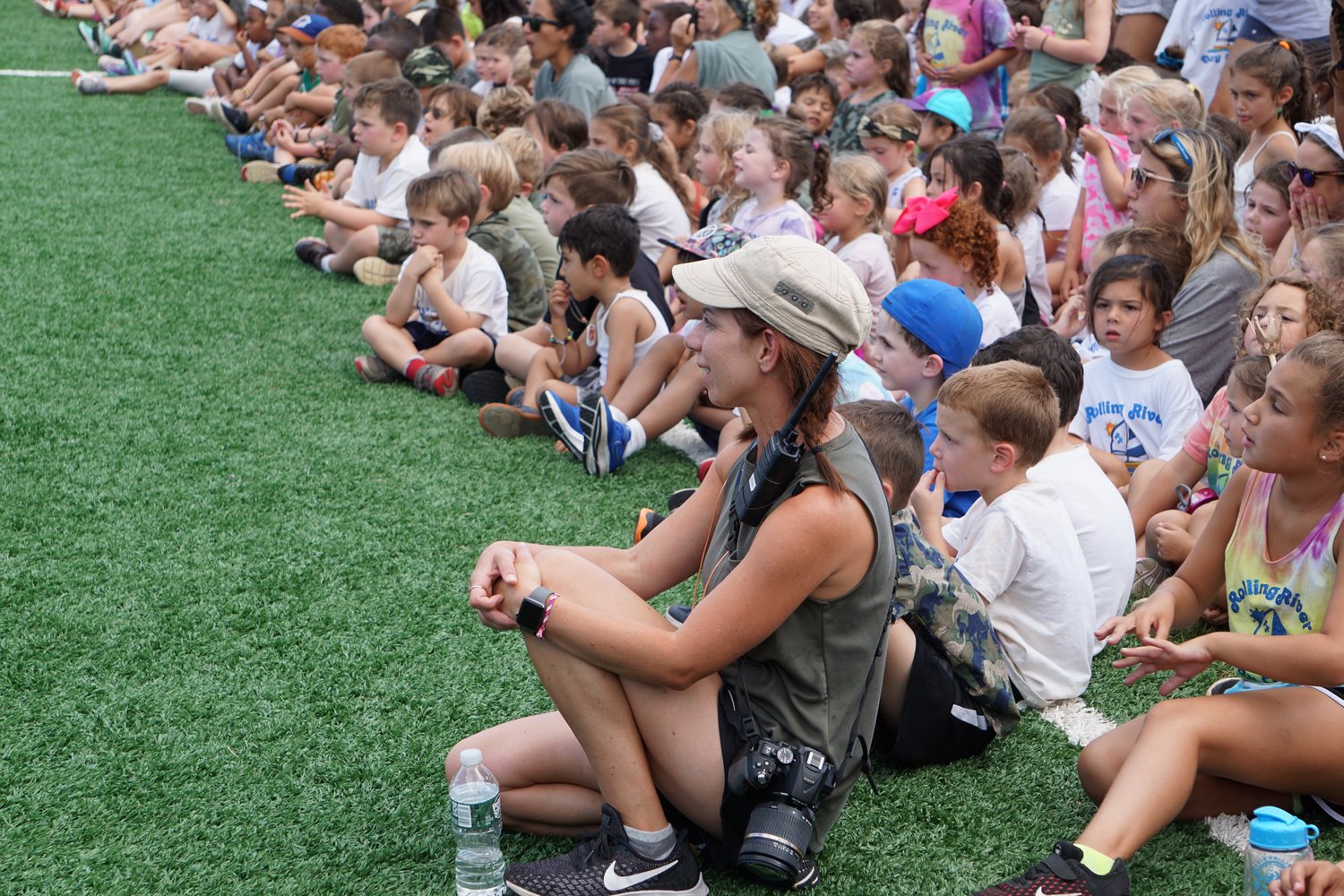 Jennifer Glatzer, communications manager at Rolling River Day Camp, sitting, center front, with the campers, as they waited to be dismissed to their next activity.