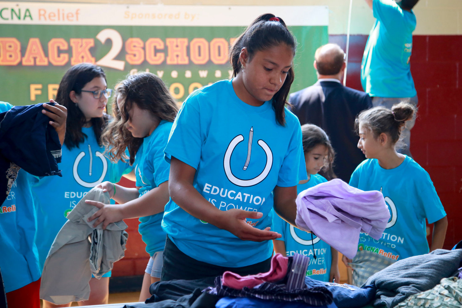 Eighth-grader Emily Flores volunteered her time to help sort the clothes distributed at the event.