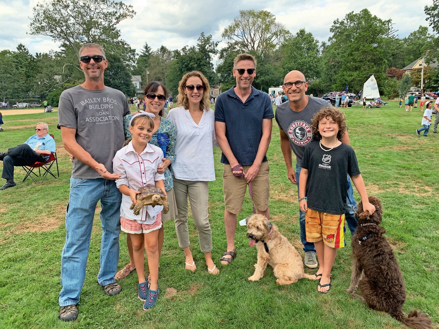 Jeff Jackson, top left; Shannon Meserve; Jess and Eric Ward; Eric Solomon and his children; and Lucy Jackson, bottom left, and Casey Solomon, both 9, brought Shelby, a tortoise; Mabel, a wheaten terrier; and Duncan, a Labradoodle.