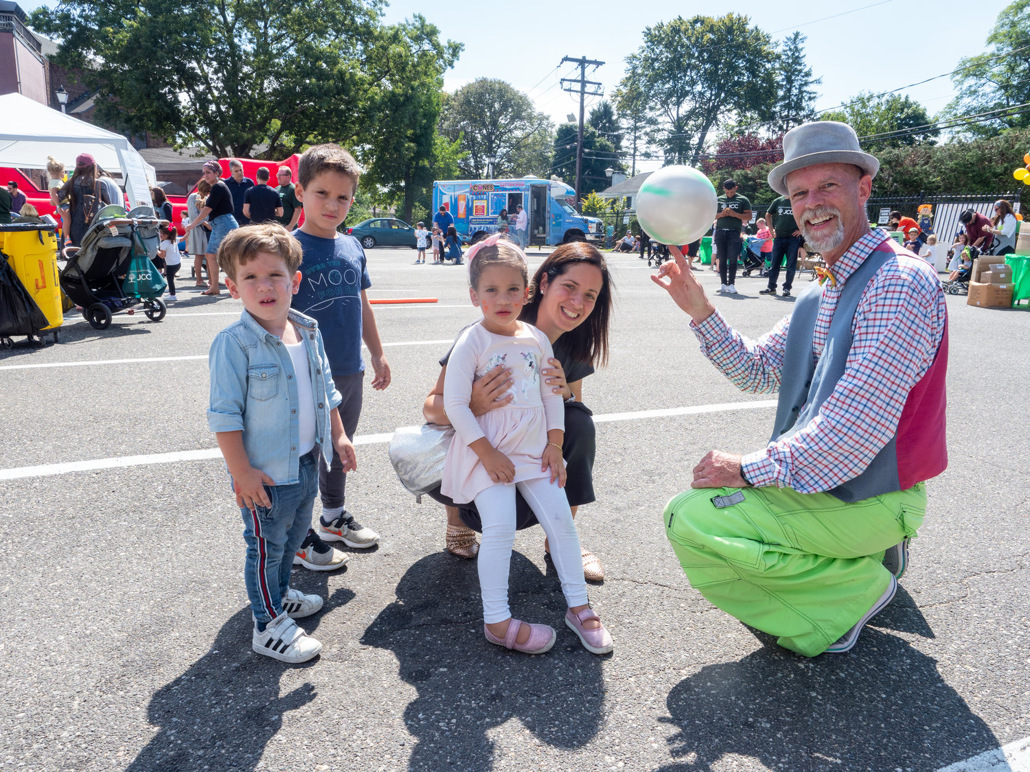 Performer Fred Collins, far right, entertained the Tawil family from left Jake, 2, Sam, 5, Linda, 4, and mother Karen at the JCC’s inaugural fall festival on Sept. 15.