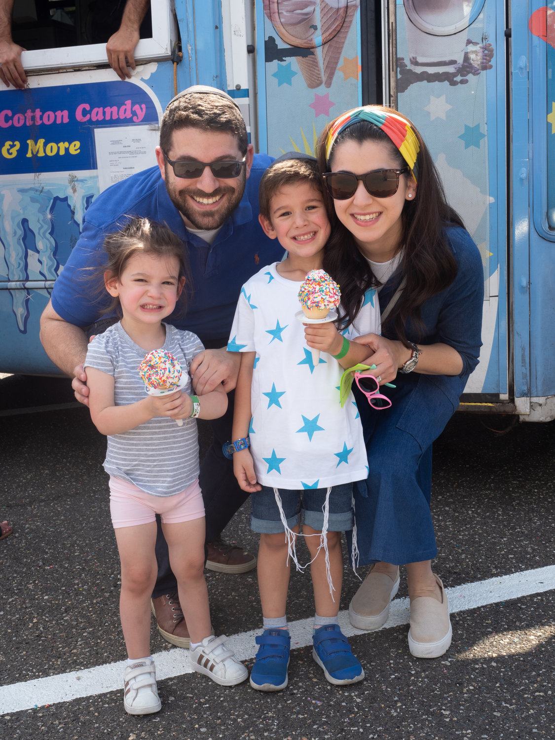 Ice cream was the treat for Zahava, 2, and Meir, 4, Weinstein with parents Yaakov and Davora at the fall festival.
