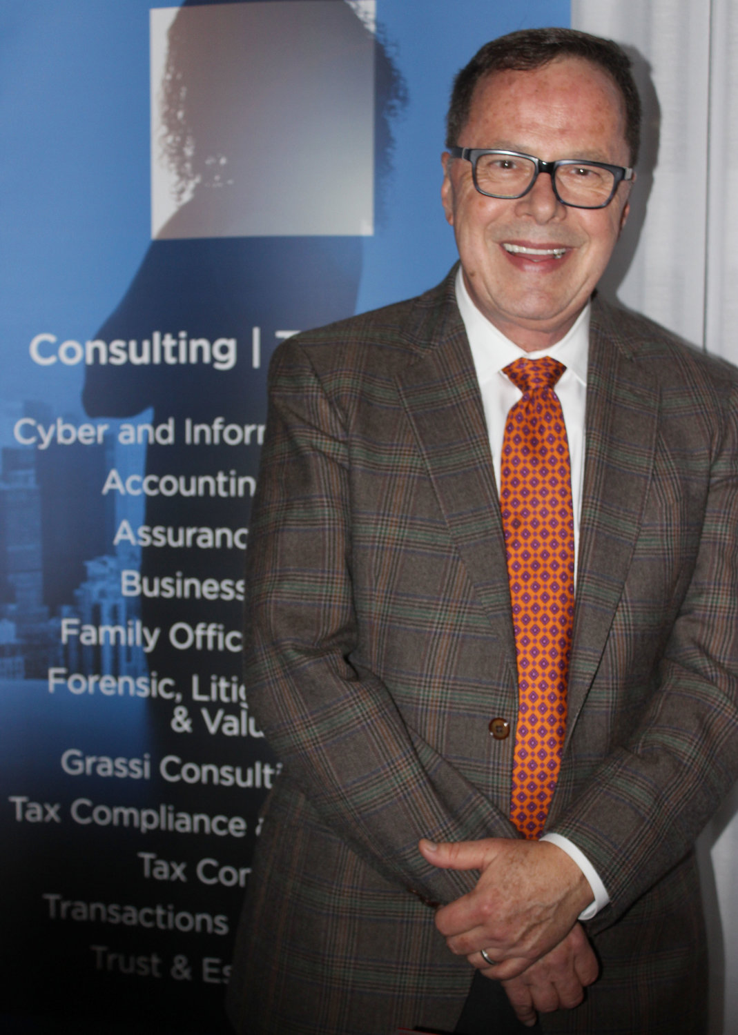 Joe Bruha, senior marketing manager of Grassi and Co., spoke to guests about the company and its mission to support local lawyers with accounting and auditing services.