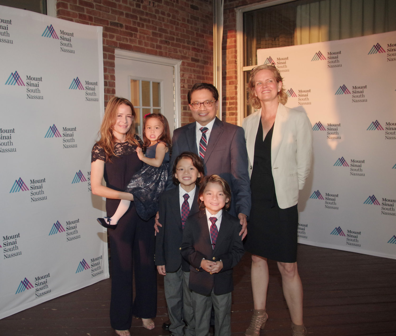 Cruz, second from right, enjoyed the honor with his wife, Kristine, far left, their three children, Riley, Tyler and Mia, and Nassau County Executive Laura Curran.