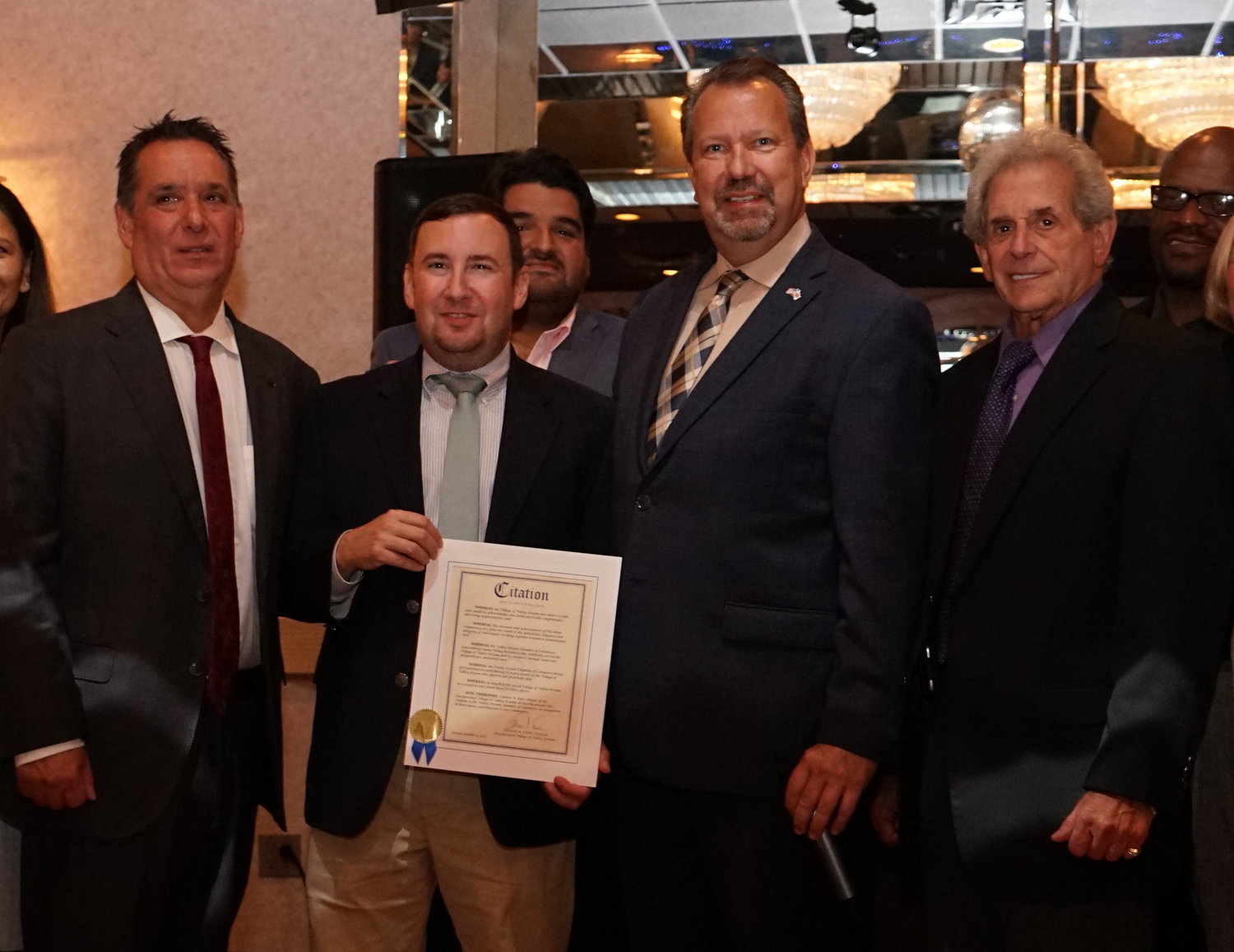 Lee Feinman, far right, with village Trustee John Tufarelli, left, Valley Stream Chamber of Commerce President Dominick Minerva and Mayor Ed Fare at a chamber dinner last month. Feinman was honored as the 2019 Nassau Council of Chambers of Commerce Businessperson of the Year for Valley Stream.