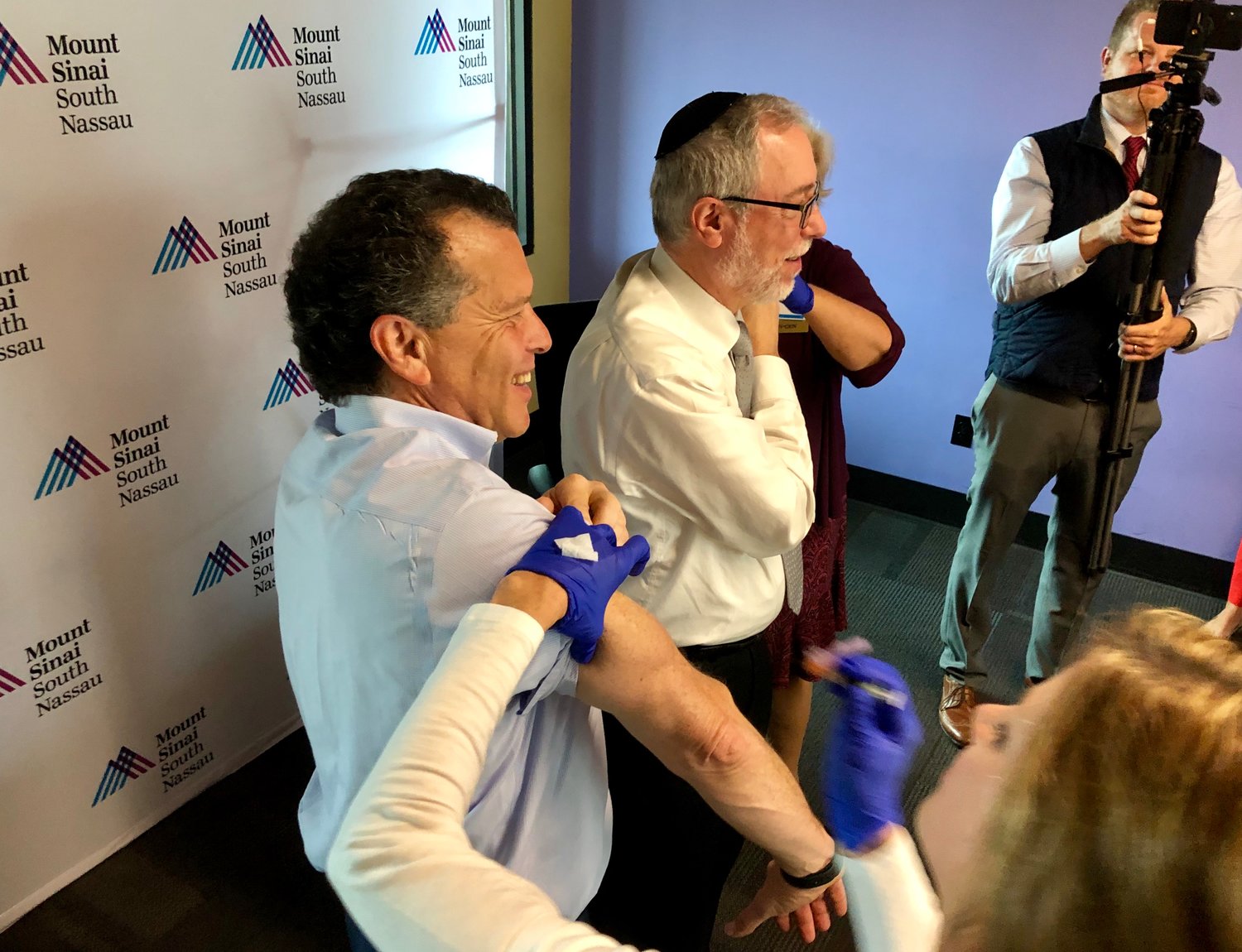 Dr. Aaron Glatt, right, chairman of the Mount Sinai South Nassau Department of Medicine, and Stuart Richner, publisher of Herald Community Newspapers, rolled up their sleeves to get their flu shots together at the Heralds’ offices in Garden City on Oct. 29.