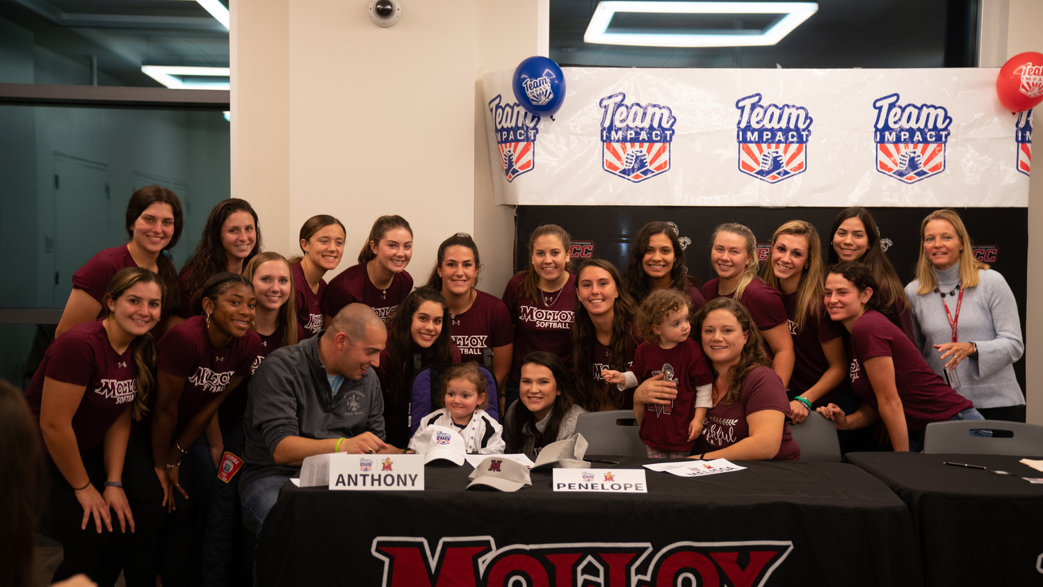 Penelope DiChiara and her family with the Molloy softball team.
