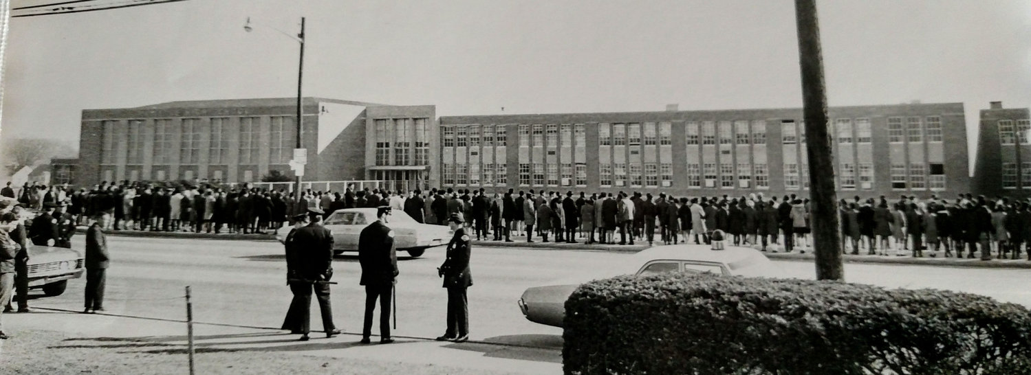 Residents and protesters crowded Ocean Avenue, in front of Malverne High School, circa 1963, over plans to integrate Malverne Public Schools.