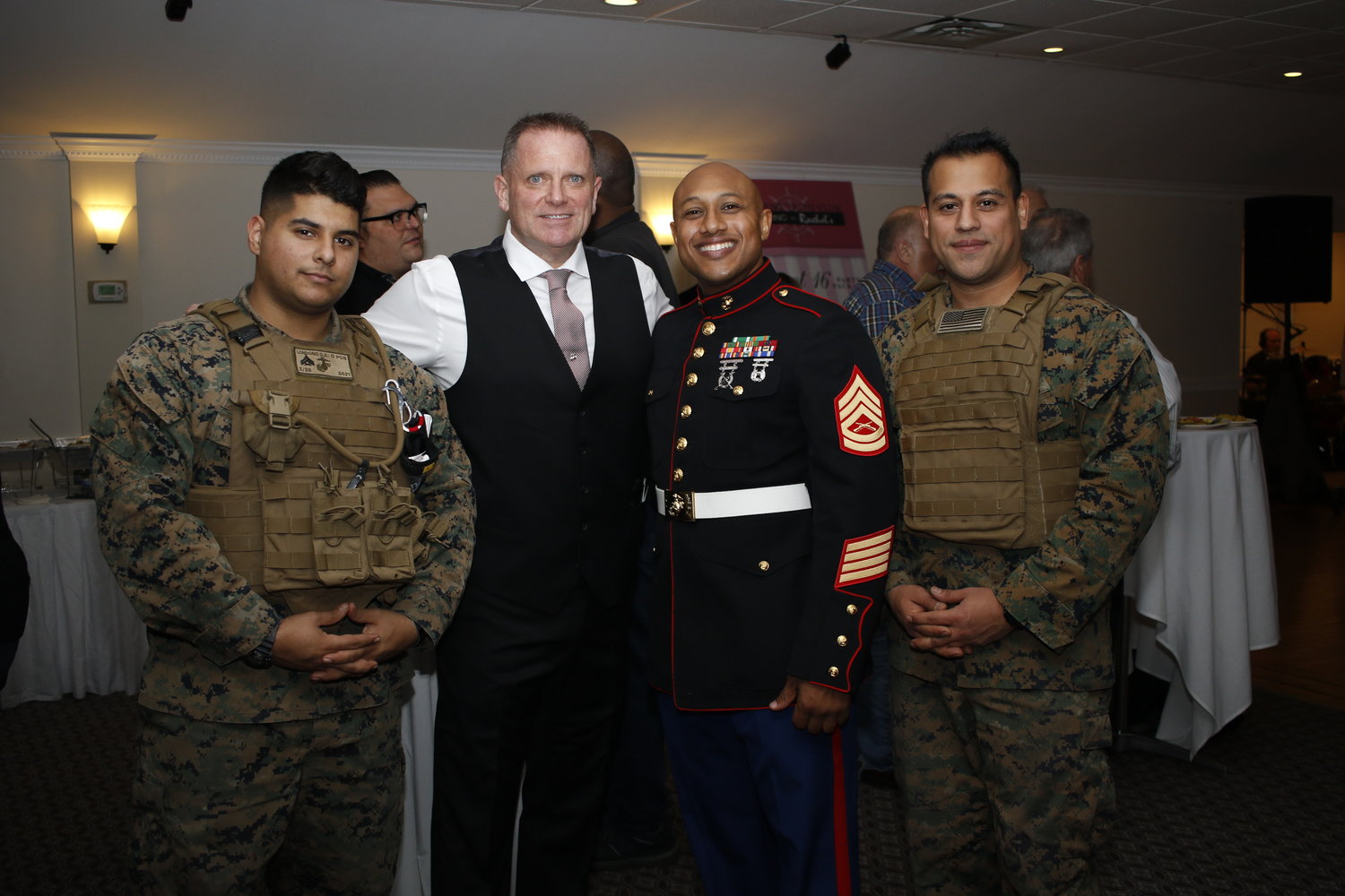 The Marines have always been a part of Toys for Tots, and several attended a fundraiser at the Freeport Yacht club on Nov. 21, above. Franzone, second from left, was joined by, from left, Andrew Londono, Fabrizio McMilland and Irvin Argueta.