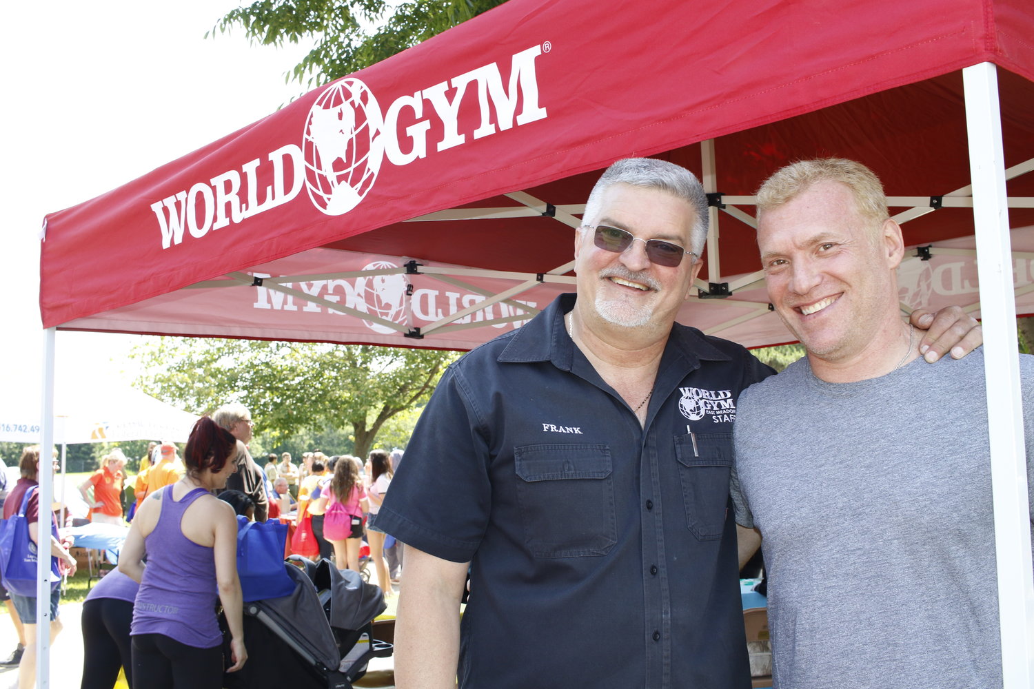 Frank Camarano, board chairman of the East Meadow Chamber of Commerce and owner of World Gym, spoke about the value of “experiential retail,” which gives customers an experience they can’t get online. Above, Camarano, left, with chamber President Michael Levy at the chamber’s annual community Pride Day in June.