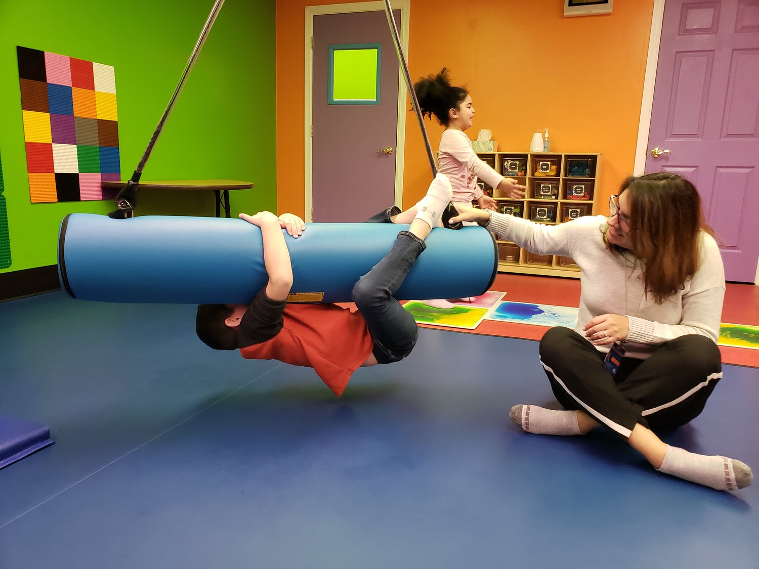 Declan Cunningham, 8, held tight on the bolster swing as Michele Floria, the school’s occupational therapist, pushed him back and forth.